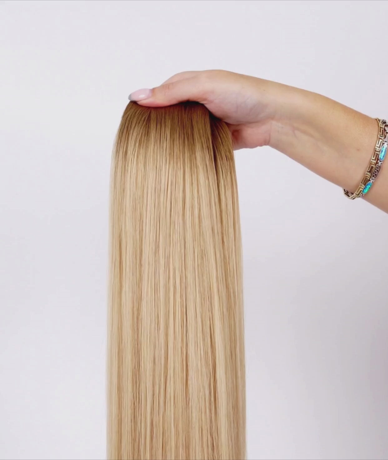 Load video: #Rooted Beach Blonde Ultra Seamless Tape In Extensions (NEW)