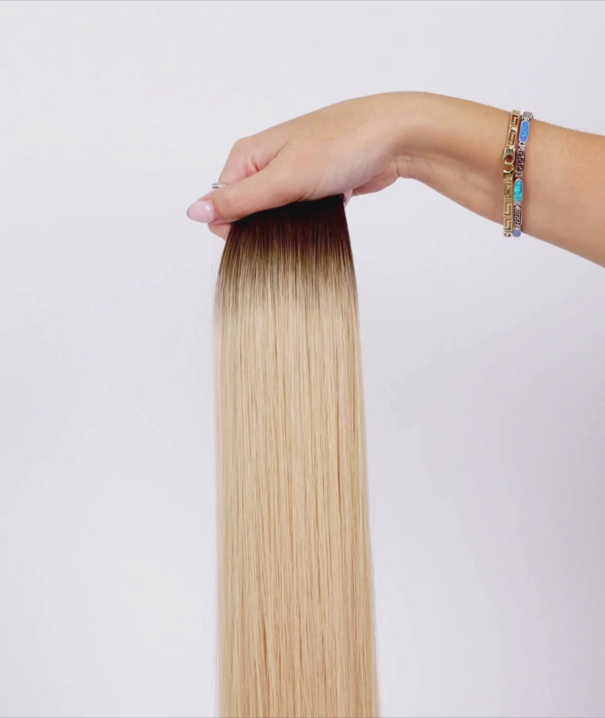 Load video: #Rooted Beach Ash Blonde Ultra Seamless Tape In Hair Extensions (NEW)
